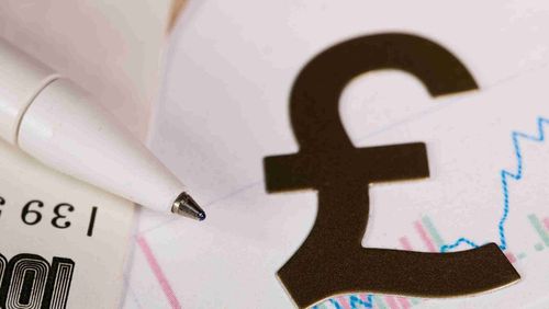 A pen and paper bill beside the British pound sign