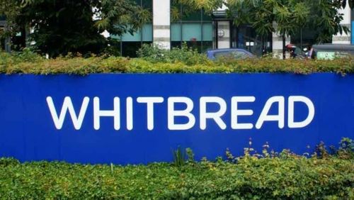 Whitbread displayed on a curved blue sign